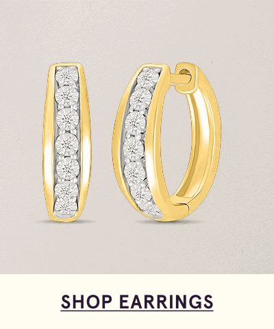 Small yellow gold huggies, adorned with vertical channel of round diamonds. Click here to shop earrings