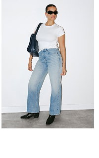 Woman wearing white t-shirt and light blue jeans
