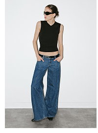 Woman wearing black sleeveless tank and wide-leg jeans