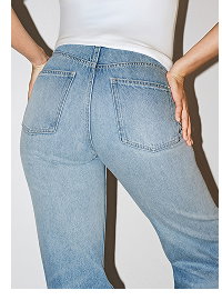 Back view of woman wearing light blue straight leg jeans