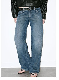 Woman wearing blue wide-leg jeans and black leather jacket