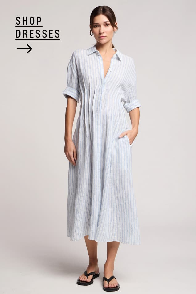 Image shows a model wearing the Saron Dress in White/Blue.