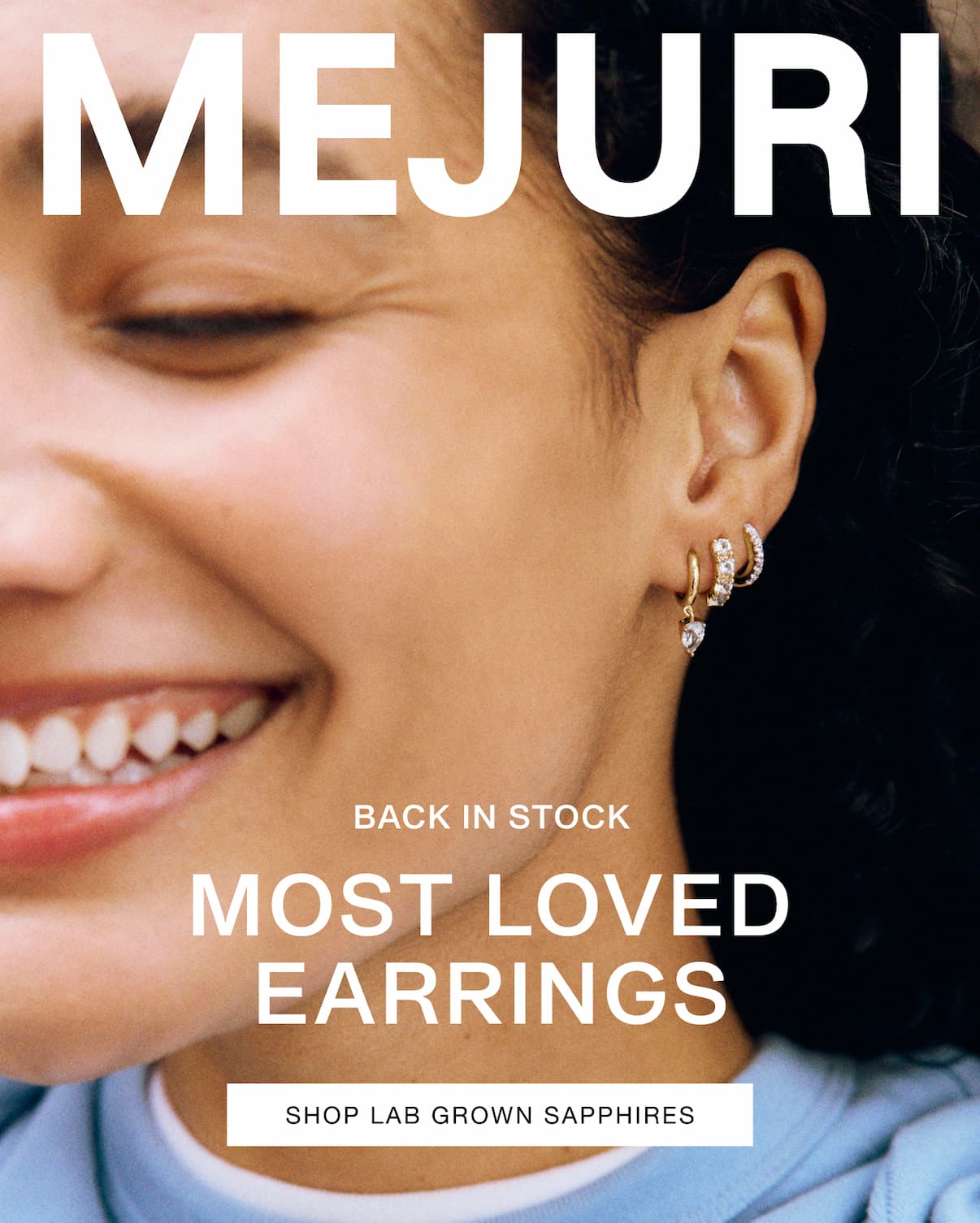 Woman wearing stacked Mejuri sapphire hoops — Back in Stock, Most Loved Earrings.