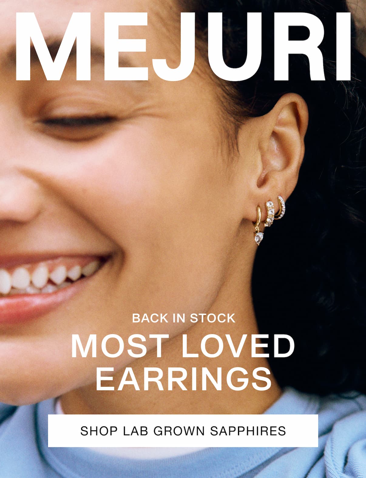Woman wearing stacked Mejuri sapphire hoops — Back in Stock, Most Loved Earrings.