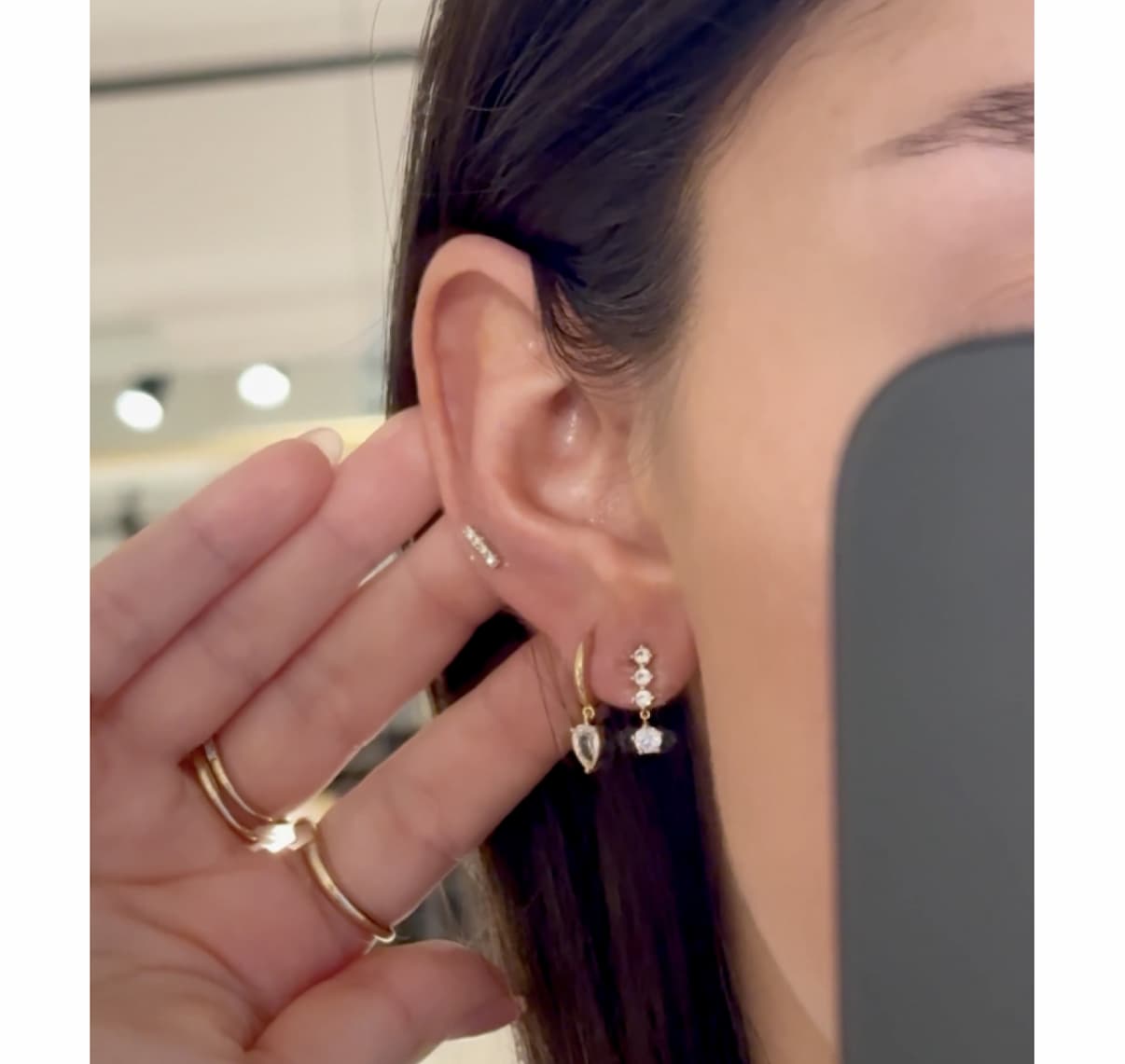 Woman wearing Mejuri earrings.