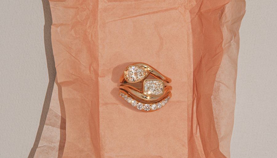 Flatlay of diamond rings on pink tissue background