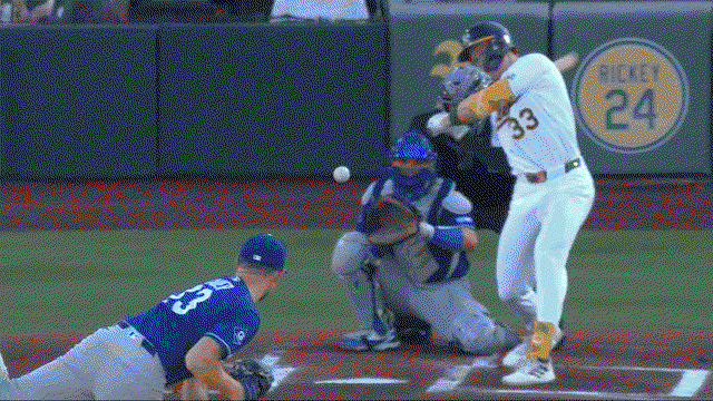 An animated gif of Eric Lauer making a no-look behind-the-back stab of a one-hopper up the middle