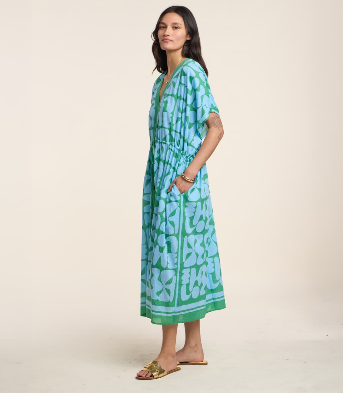 Image shows a model wearing the Amira Dress in Blue/Green.