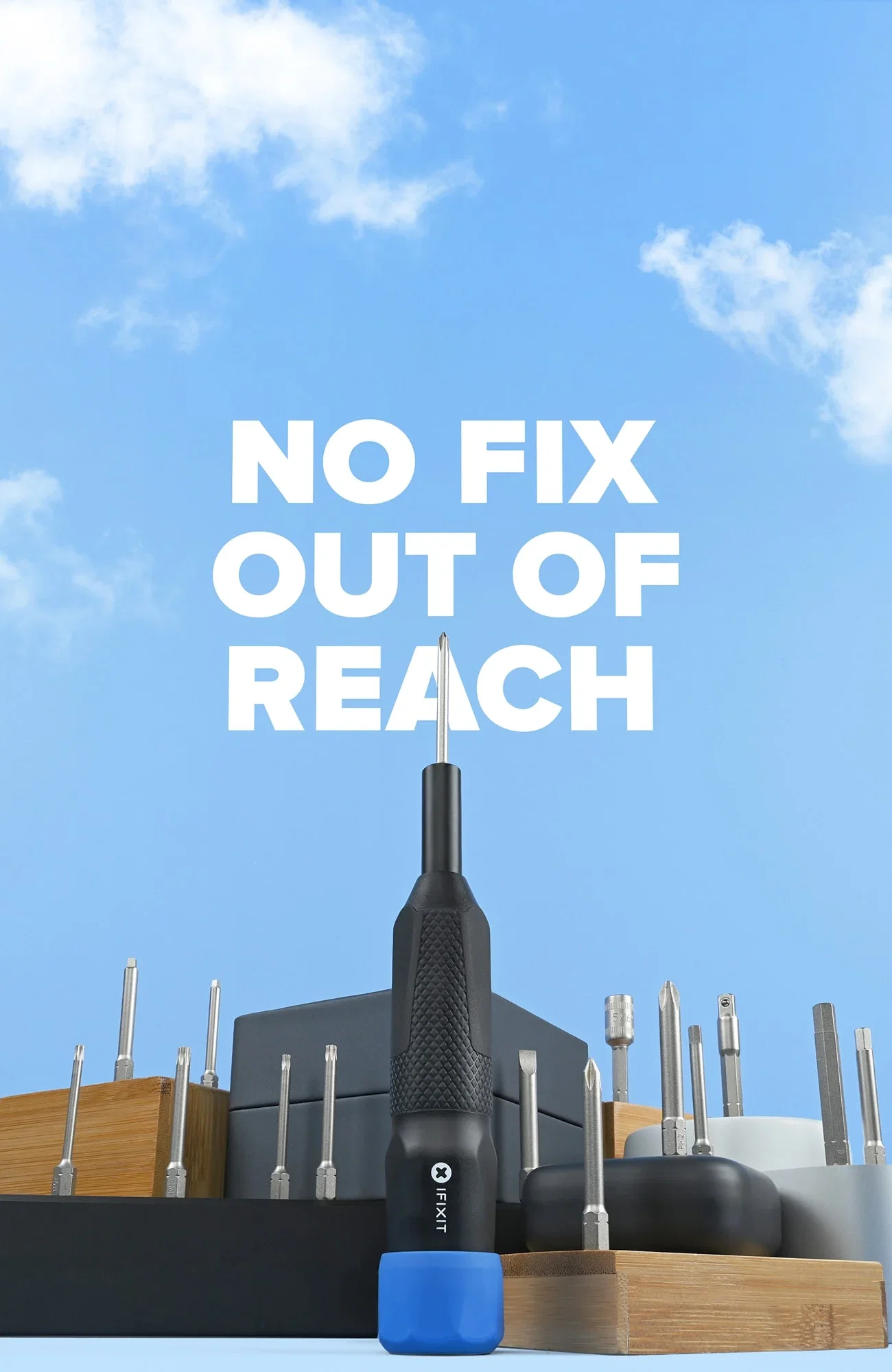 Product hero image showing the new iFixit Megalodon screwdriver standing upright among neatly arranged driver bits, set against a blue sky background with the headline “No Fix Out of Reach.”