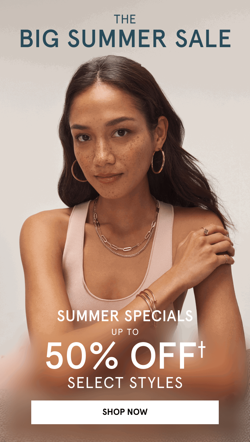 Model wearing a collection of gold jewelry, layered chain necklaces, bangles, hoop earrings, and rings. The Big Summer Sale. Summer Specials up to 50% Off Select Styles. Click Shop Now. 