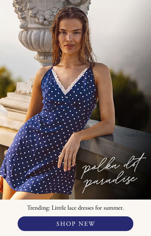Model wearing a navy polka dot mini dress. Shop new. 