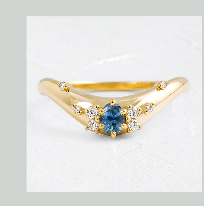 A 14k yellow gold Amplify Cluster Band in Sapphire shown on a textured white background.