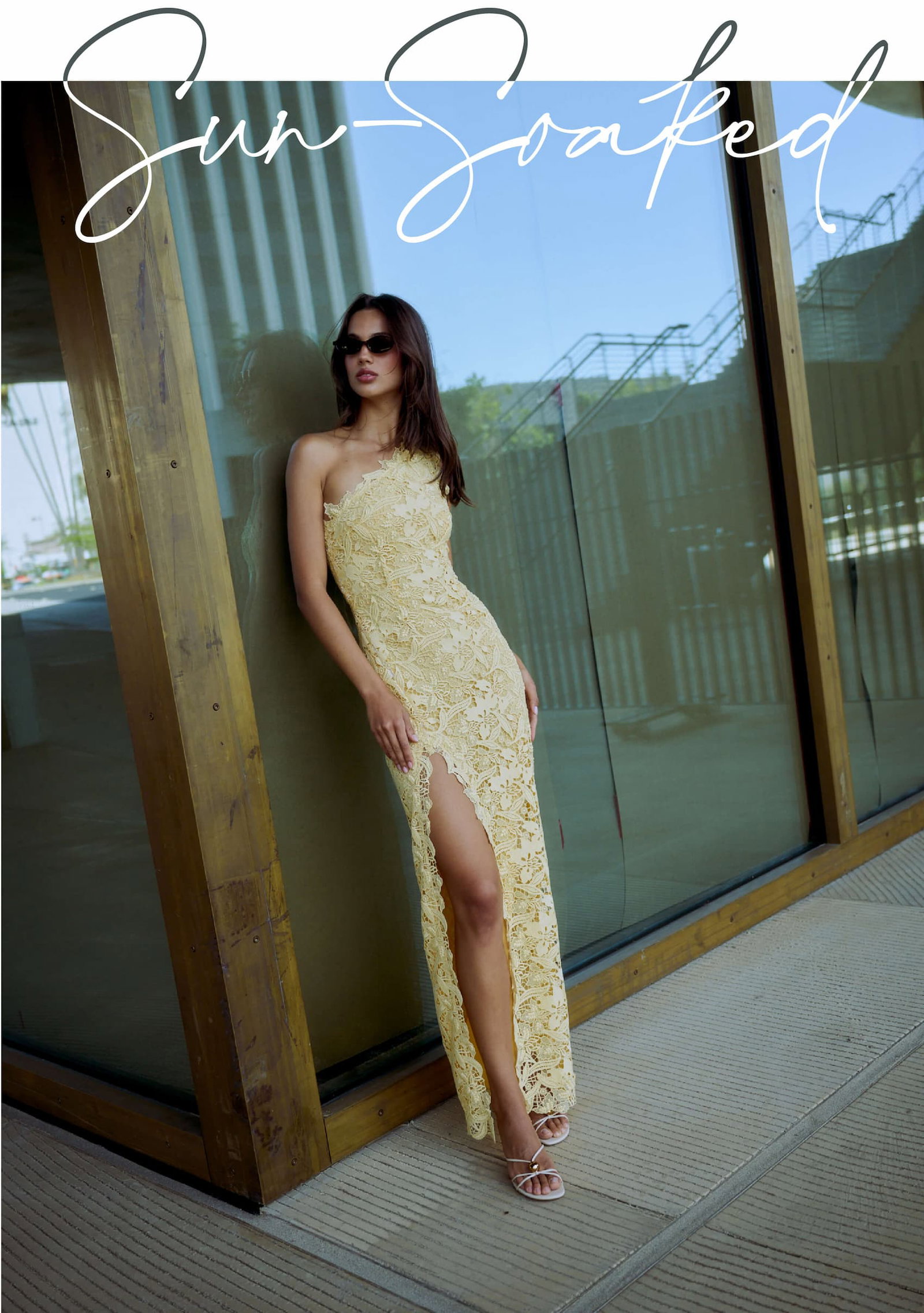 Model wearing a citrine yellow one-shoulder lace dress with high leg slit.