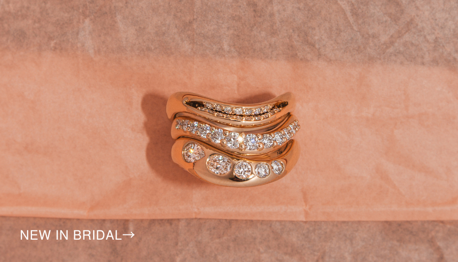 Flatlay of diamond rings on pink tissue background