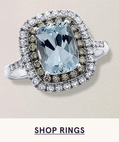 Cushion-cut light blue gemstone center & double halo of diamonds, set on diamond-accented band. Click here to shop rings