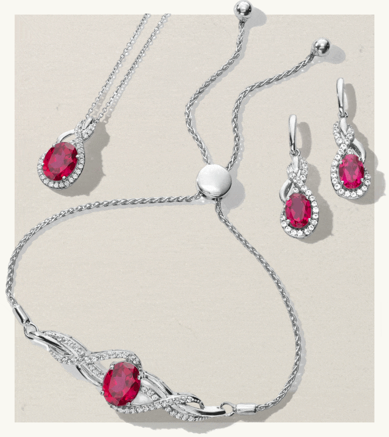 Rotating set of ruby halo pendant necklace, ruby drop earrings & bolo bracelet with a ruby stone, appearing.
