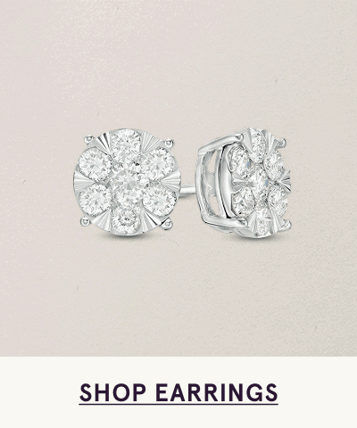 Round silver studs with diamond clusters creating flower-like design. Click here to shop earrings