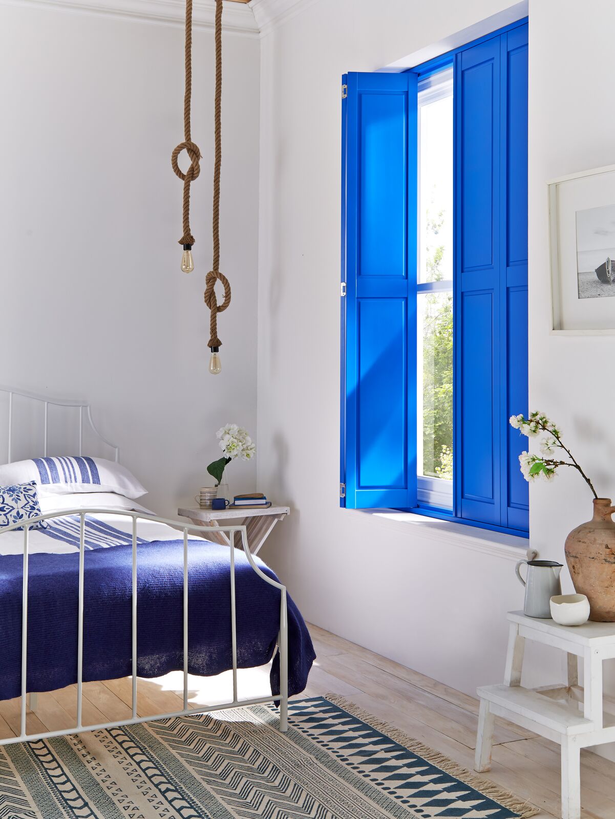 Blue coloured shutters for a Greek inspired island bedroom