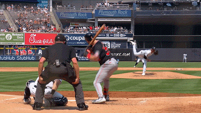 An animated gif of Paul Blackburn making a no-look, between-the-legs play on the mound