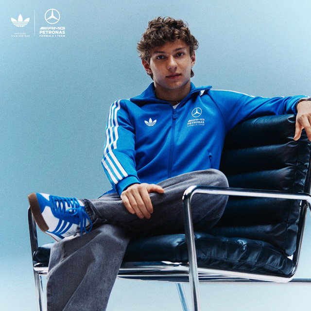 Kimi Antonelli wearing blue track jacket and sitting in a chair 
