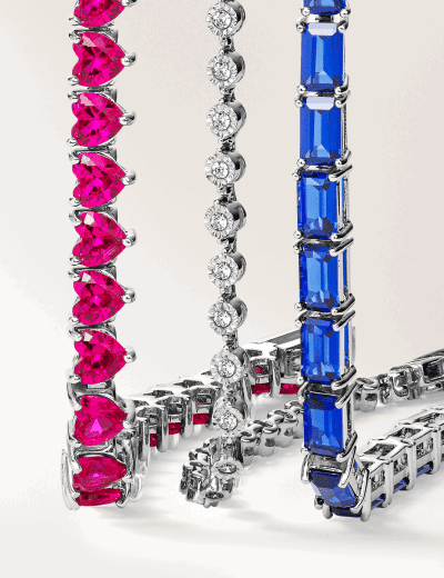 Three gemstone chain bracelets. One ruby, one diamond, one sapphire. 