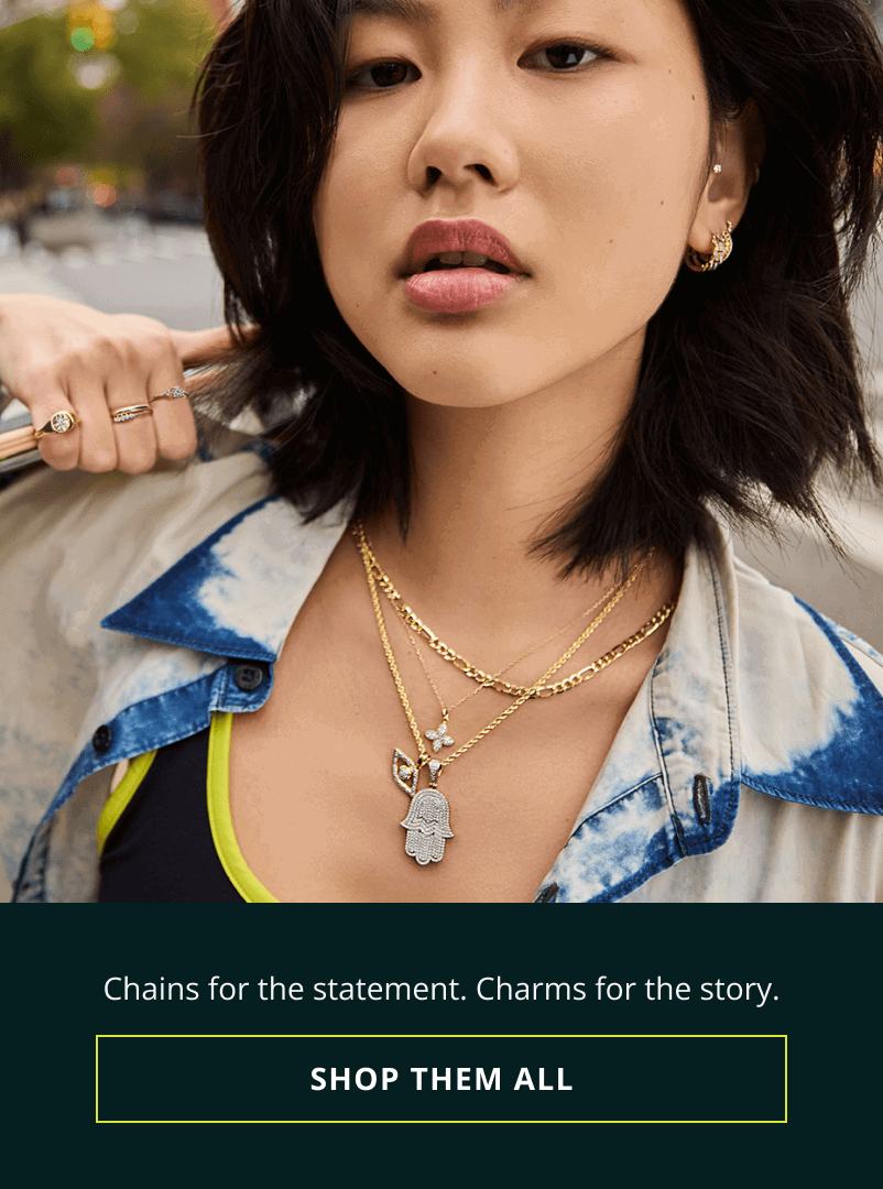 Focus on model’s gold rings, huggies & chains: including evil eye & Hamsa pendant. Chains for statement. Charms for the story.  Click here to shop them all