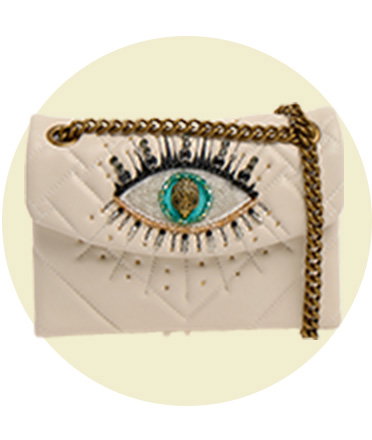 Cream quilted bag with a gold chain strap, featuring an embellished eye design.