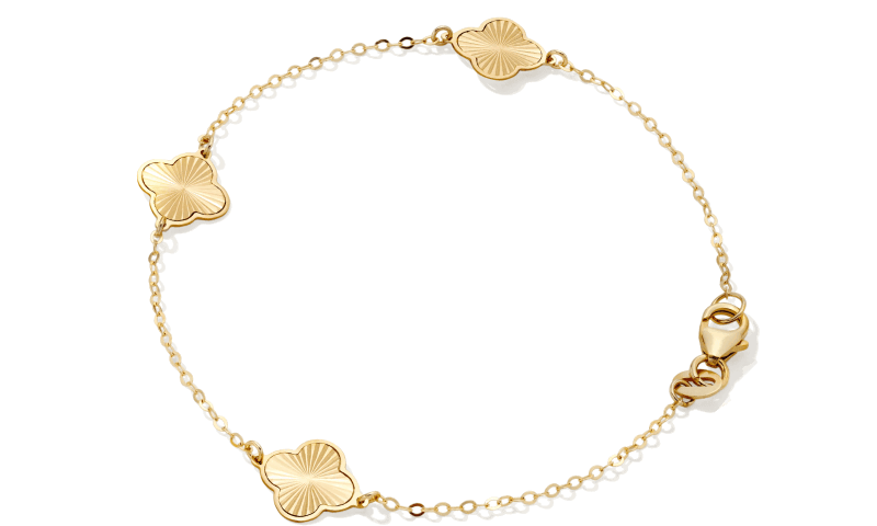 Gold bracelet with clover accents. 