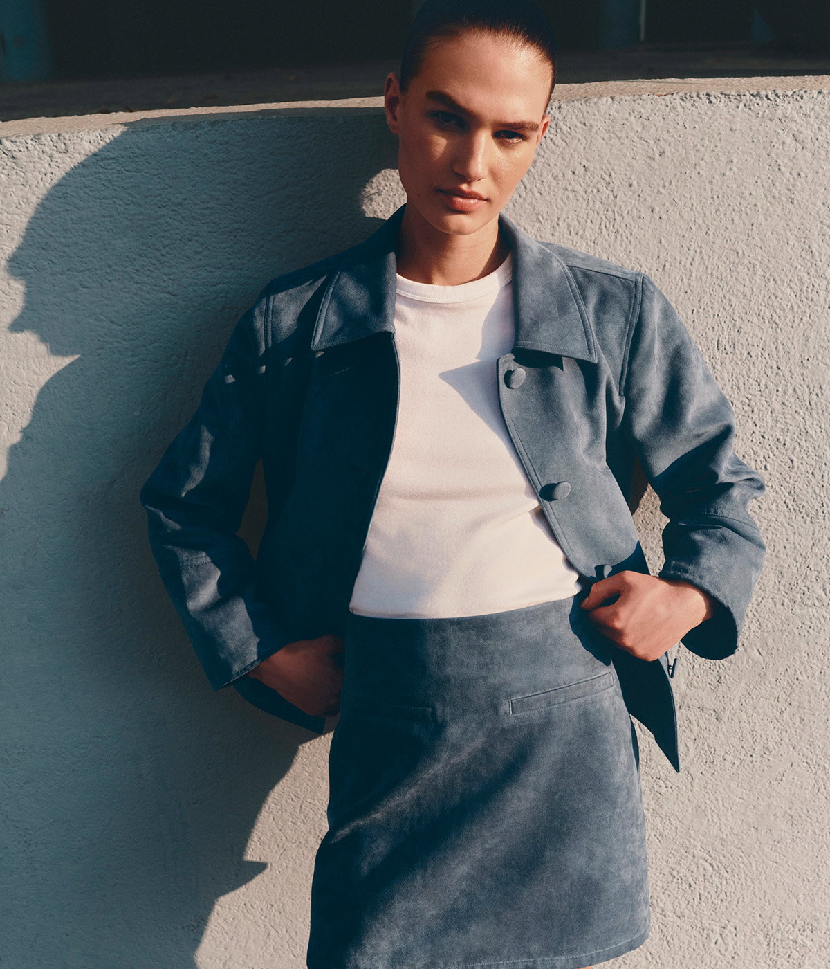 Woman wearing a Grey Blue Suedette Button Through Short Jacket and Mini A-Line Skirt