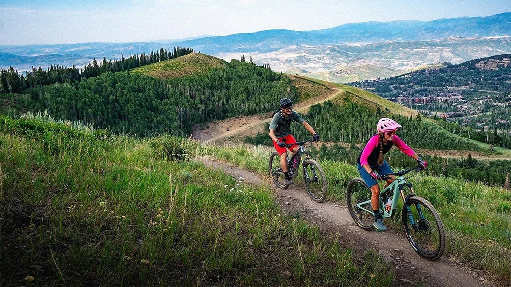 Image description: Couple mountain biking in Park City, Utah.
