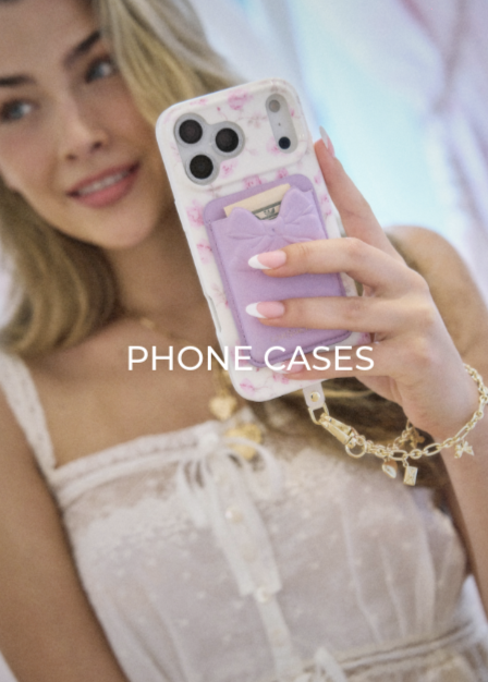 A girl holding up her Ribbon Rosa Flora phone case.