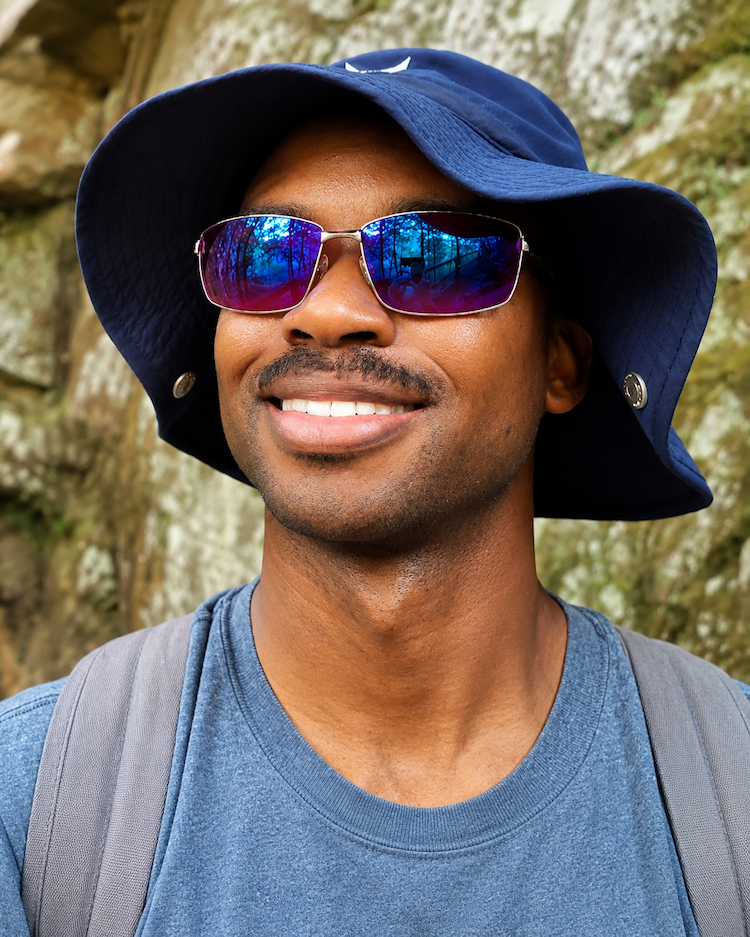 Hiker wearing EnChroma Colorado frames on the trail