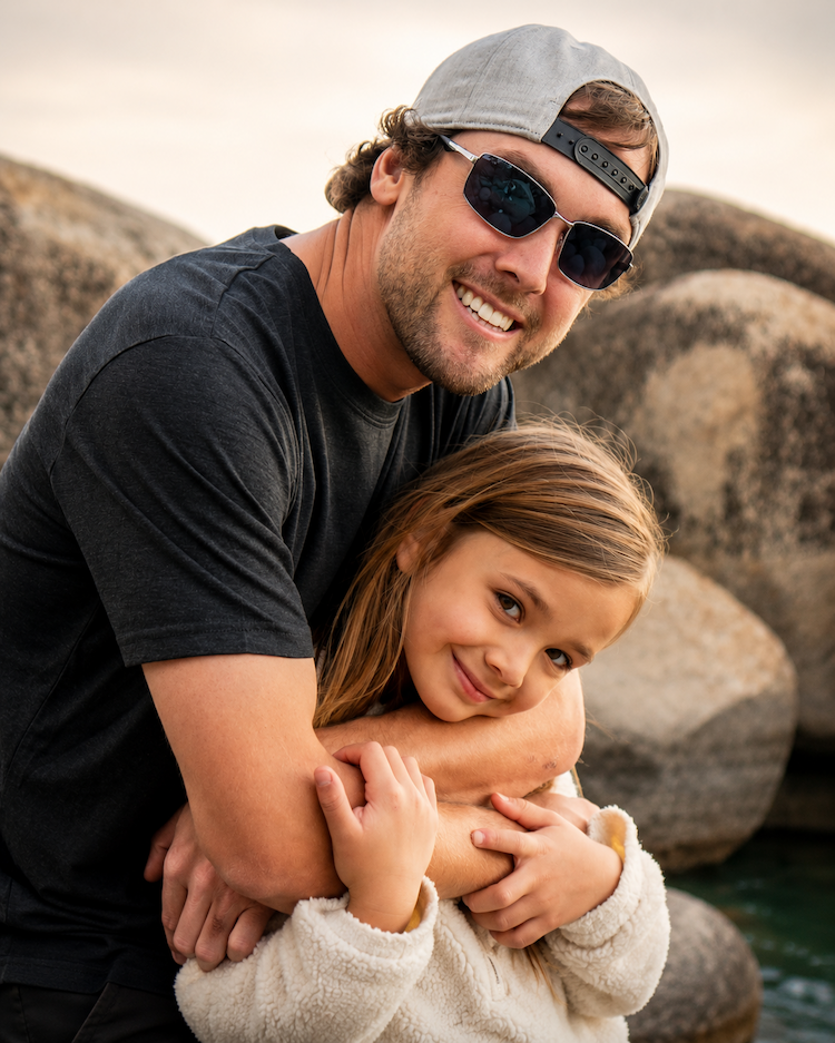 Dad wearing EnChroma Colorado frames hugging his daughter