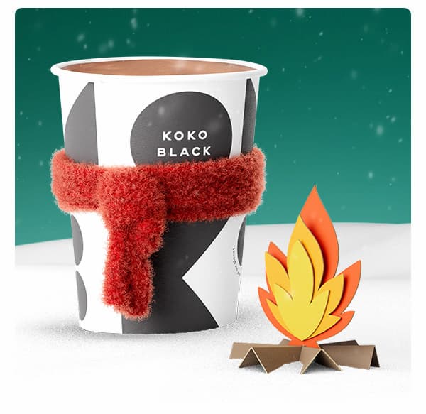 Hot chocolate in a takeaway cup with a scarf on