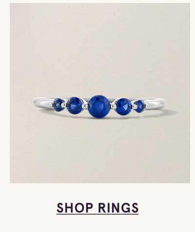 Delicate silver ring with vibrant blue stones. Click here to shop rings
