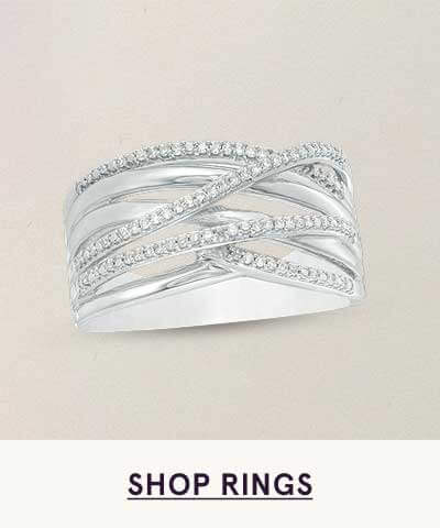 White metal ring with crisscrossing bands encrusted  with pavé-set diamonds. Click here to shop rings