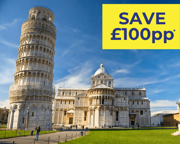 The Leaning Tower of Pisa beside the Pisa Cathedral under a clear blue sky.