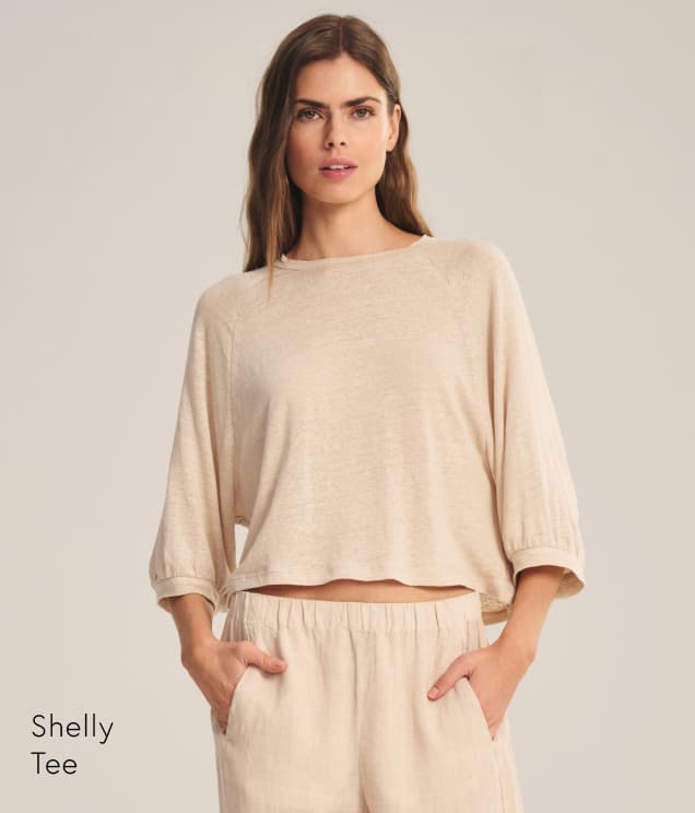 Image shows a model wearing the Shelly Top in Sandcastle. Text Reads: Shelly Tee