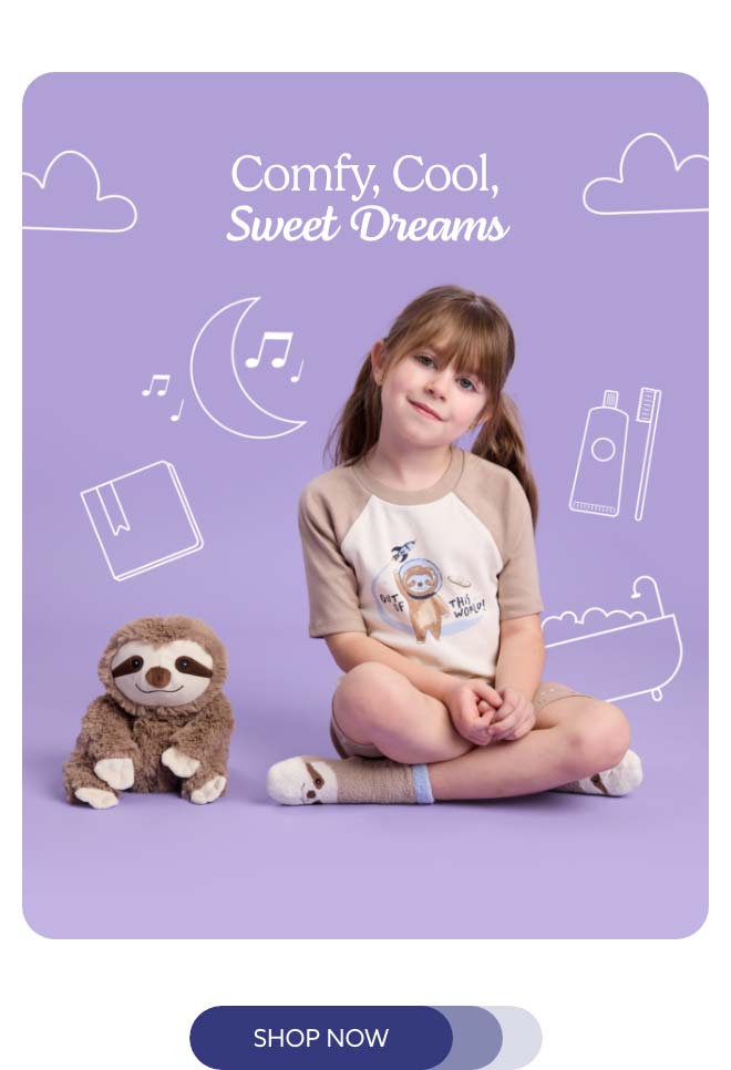 A little girl wearing Sloth Shorties next to Sloth Warmies. Shop Now.