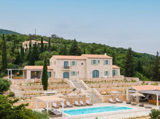 A large villa with a pool and lounge area.