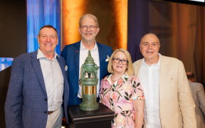 Executives at Autodesk around a trophy