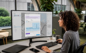 a woman in an office looking at a computer screen with the software featured