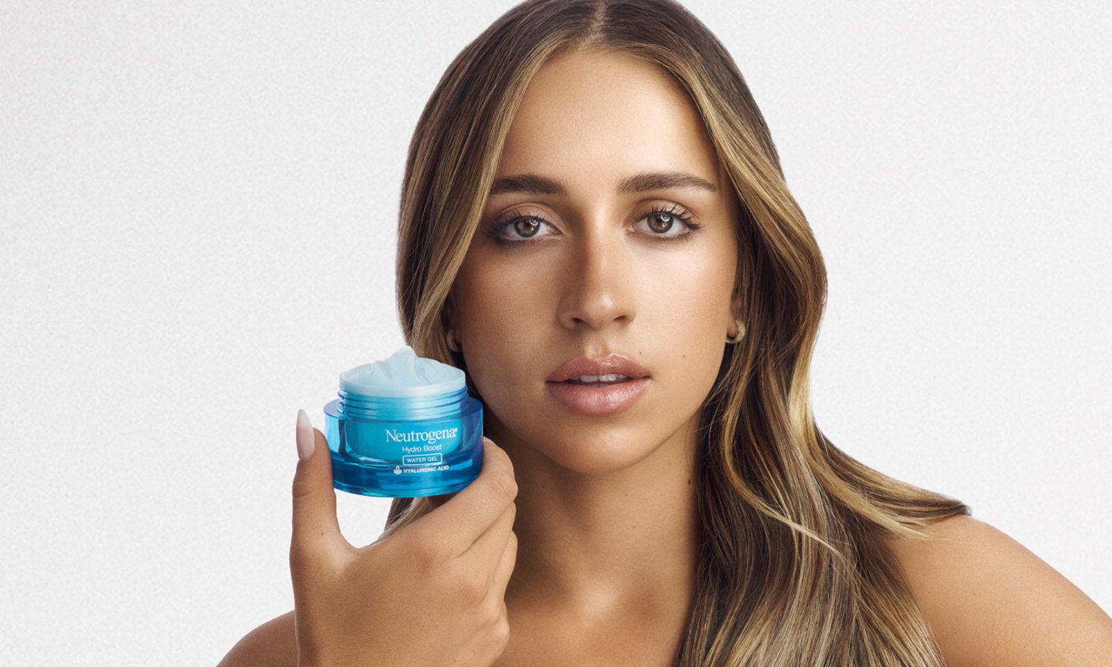 Tate Mc Rae holding an open jar of Neutrogena® Hydro Boost Water Gel