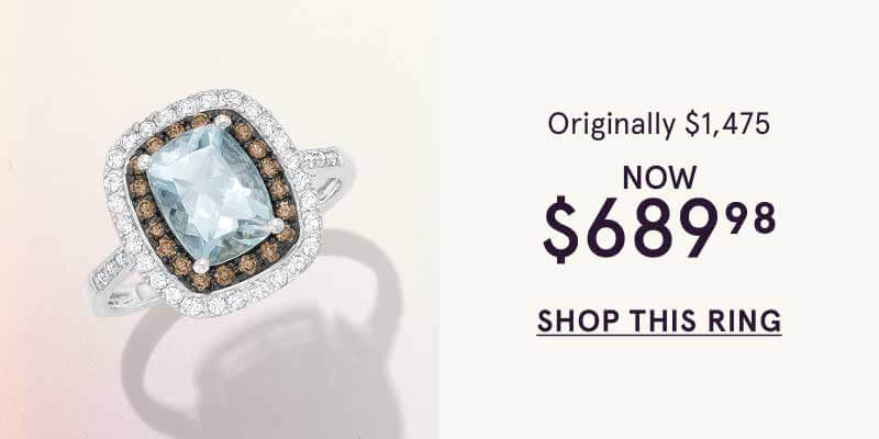 Cushion-cut light blue ring framed by brown & classic diamonds.  Orig: $1,745. Now: $689.98. Click here to shop this ring