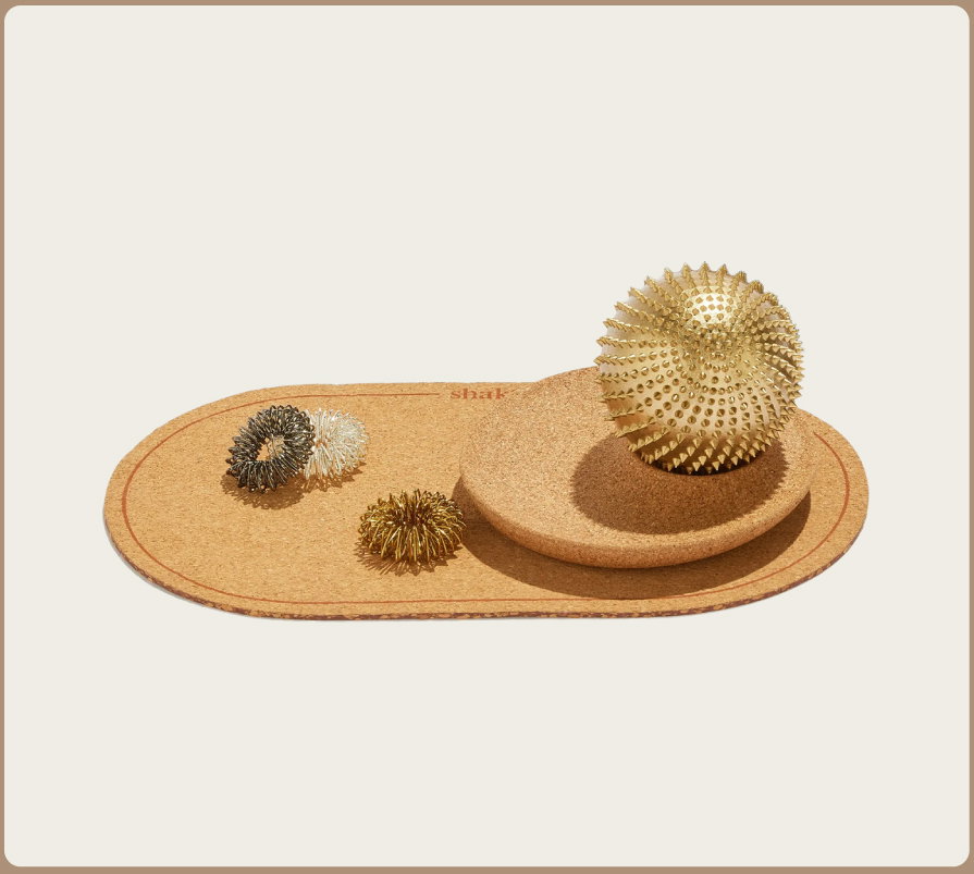 Shakti Wonderball and Torus Rings sitting on cork base