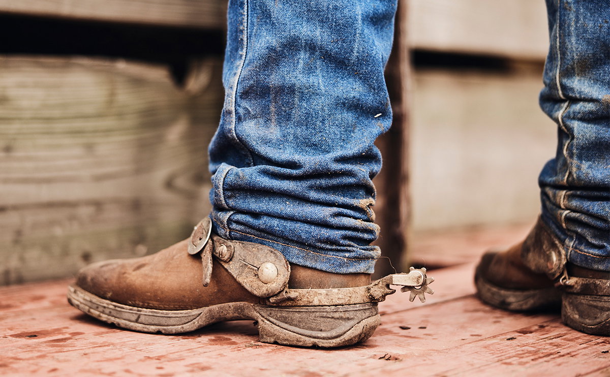 Cowboy boot in stirrup on horseback