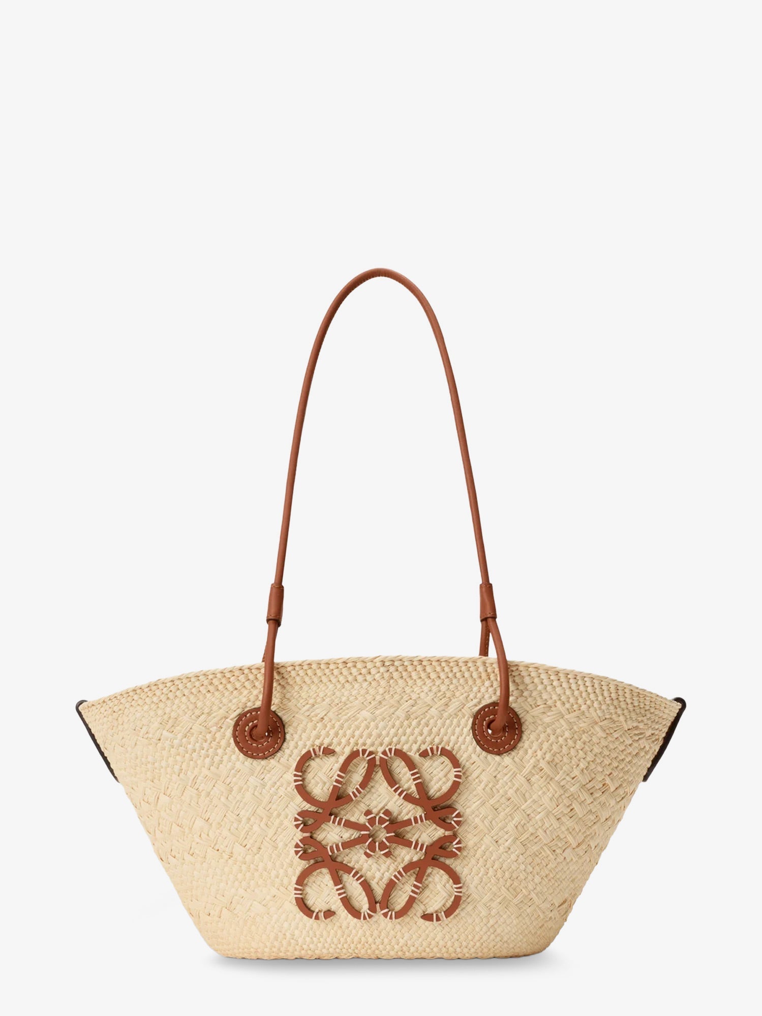A straw tote bag with a brown leather flap and gold YSL logo.