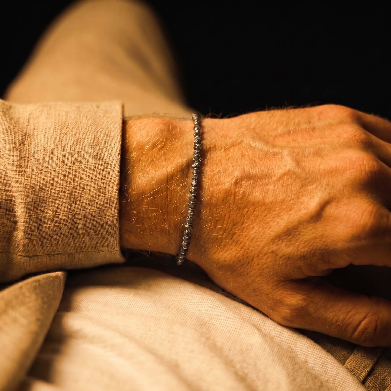 The new 3-4mm raw black diamond bracelet worn on the wrist