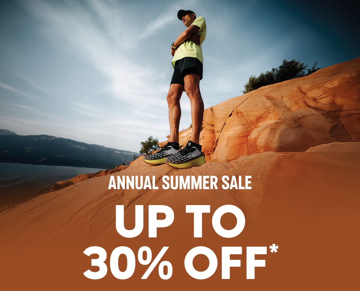 A man standing on rocky terrain with text: ANNUAL SUMMER SALE UP TO 30% OFF*