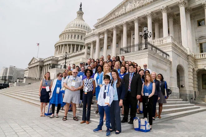 Autism advocates gather on the steps of the U.S. Capitol during a congressional advocacy event